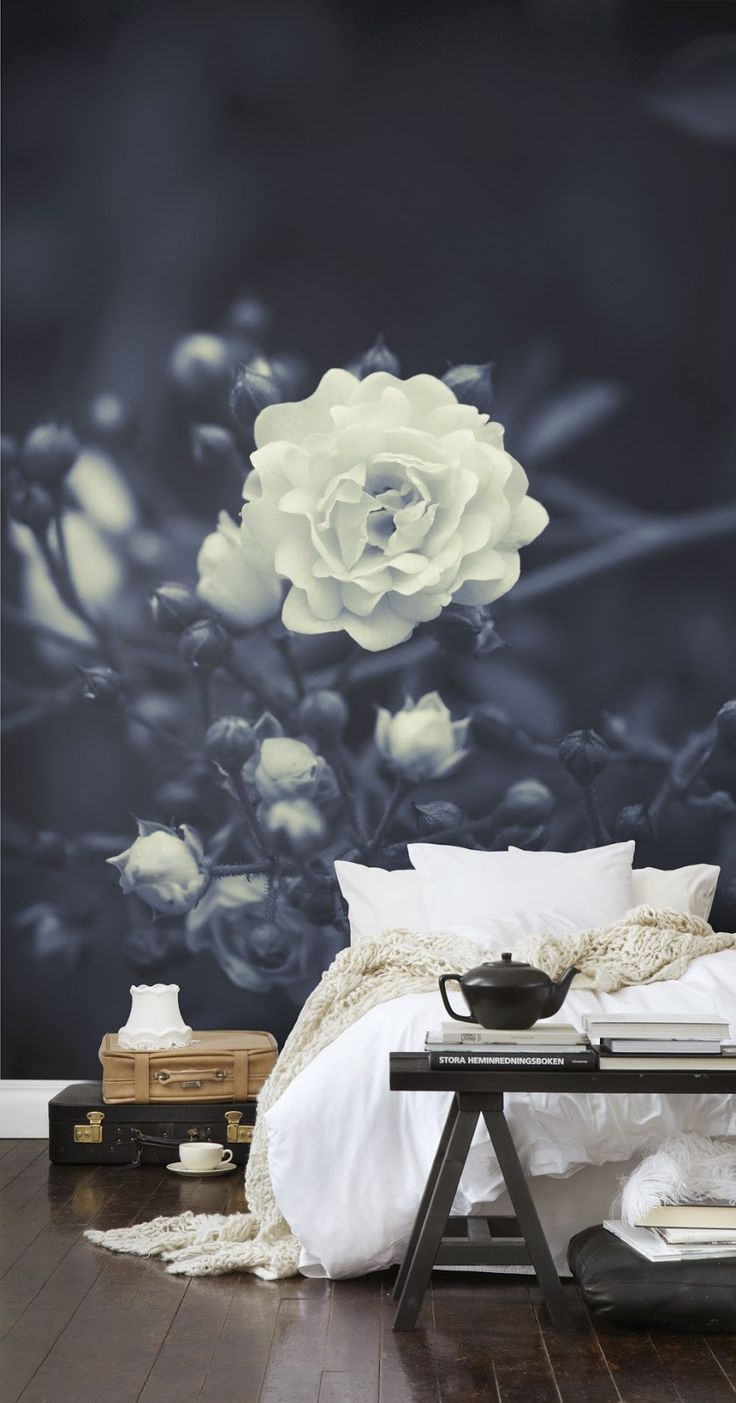 A monochromatic bedroom with a black and white floral wall mural that is elegant, chic and takes over the whole bedroom