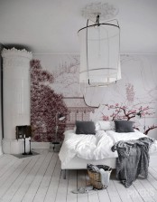 a catchy Nordic bedroom done in mostly white, with a pink Japanese wall mural with sakura and a temple that changes the whole room