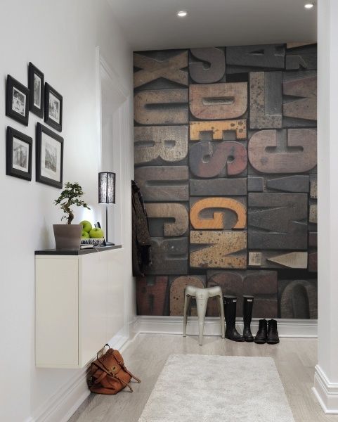 a neutral contemporary entryway with a wooden letter wall mural that adds texture, interest and catchiness