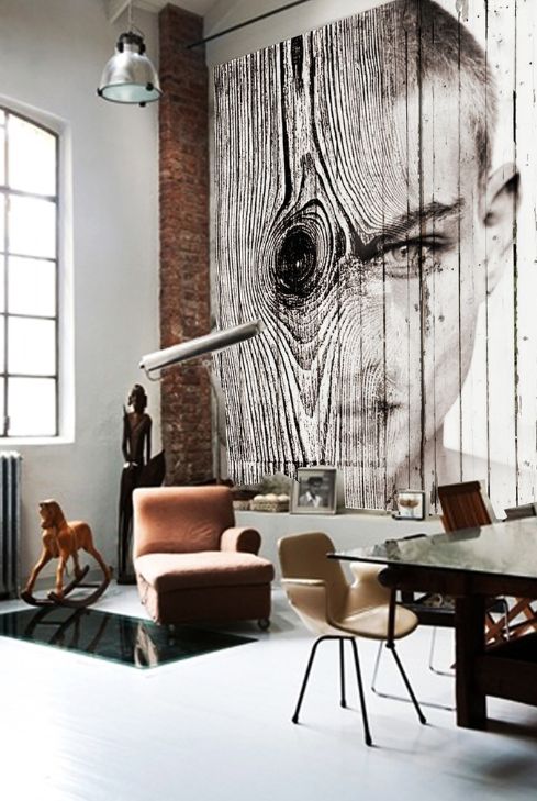 A contemporary space with a unique wood imitating and portrait wall mural that catches an eye