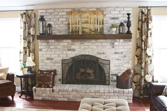 a whitewashed brick fireplace with a mantel, candle lanterns, an artwork will bring coziness to the space