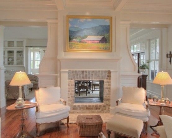 an elegant living room with a white non-working fireplace with a whitewashed brick part looks chic and brings coziness