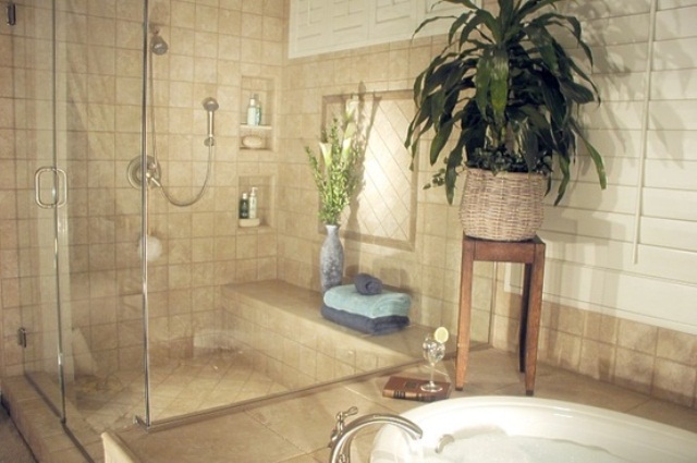 A neutral bathroom with potted greenery in the shower and tub zone, it will refresh any space at once