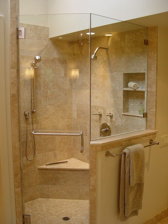 A neutral and warm colored bathroom with a shower space with a pony wall is a lovely and welcoming space