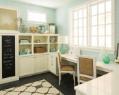 a pretty beachy home office wiht light blue walls, a large white storage unit and a shared desk, beach and sea-themed decor