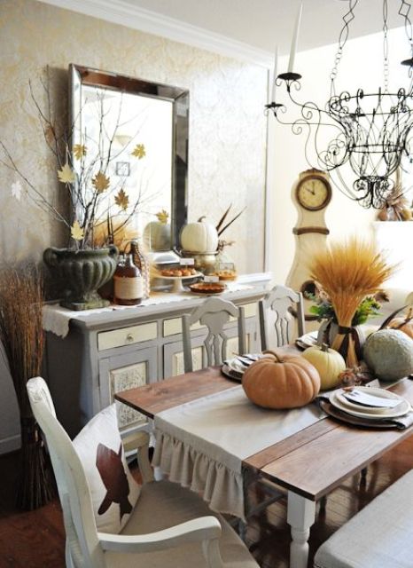Fall leaves on branches, heirloom pumpkins, feathers, a wheat arrangement will make your dining room more fall like