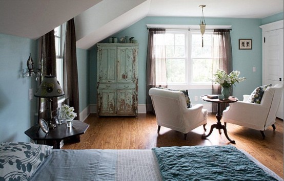 a vintage-inspired bedroom in a lighter shade of blue, with touches of creamy, grey and brown
