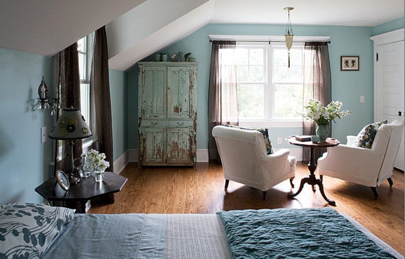 A vintage inspired bedroom in a lighter shade of blue, with touches of creamy, grey and brown