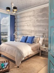 a light grey and silver bedroom infused with bold blue – pillows and curtains of this shade