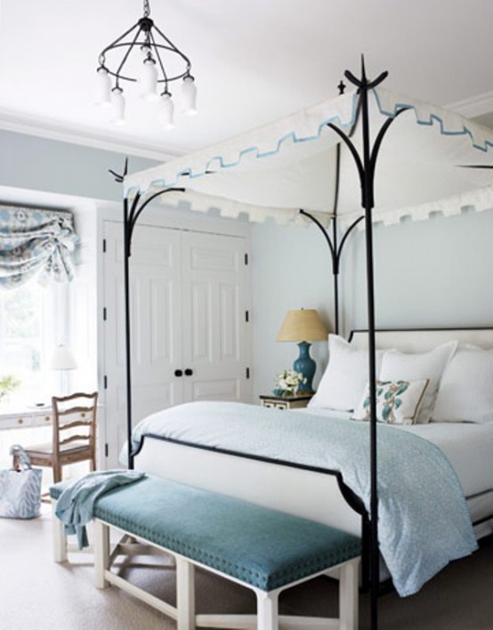 a light blue and creamy bedroom with touches of black for more drama