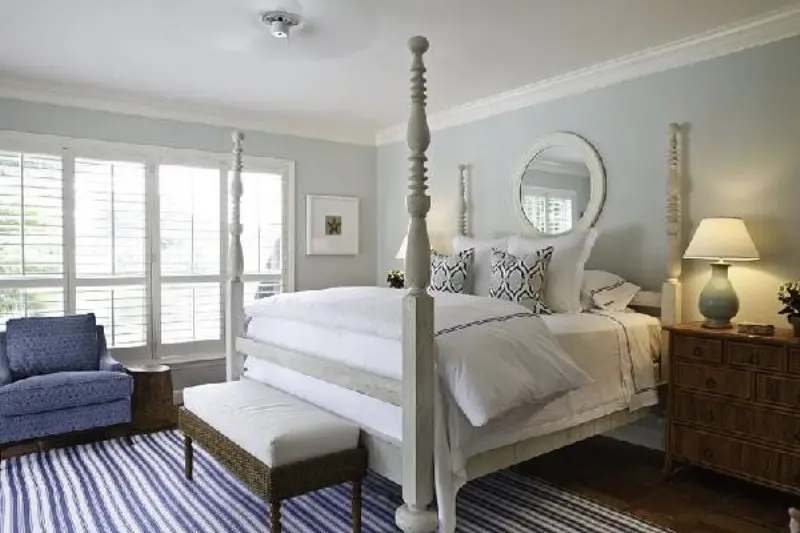 A dove grey vintage inspried bedroom with touches of bold blue