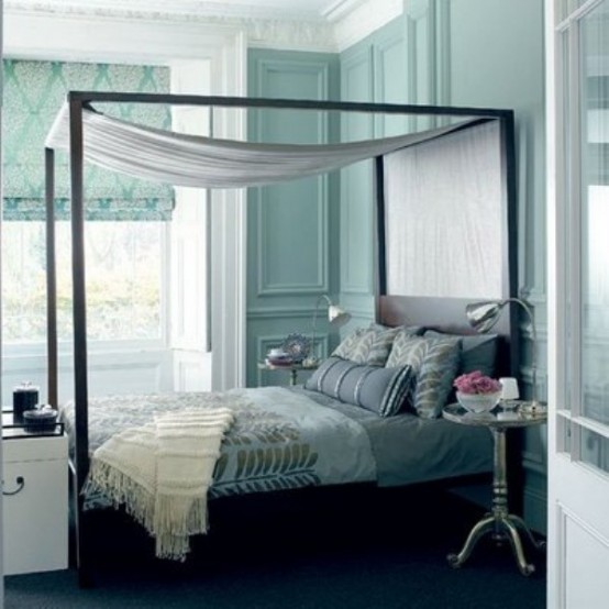 a tiffany blue bedroom with a bed done with grey and silver bedding and a silver canopy