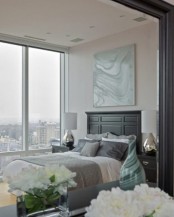 a light grey and creamy bedroom done with touches of tiffany blue