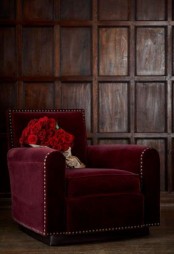 a burgundy velvet chair with decorative nails trim is a statement for a fall space
