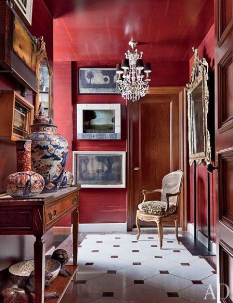 A refined entryway done with burgundy walls   for those who are ready to paint and repaint the spaces