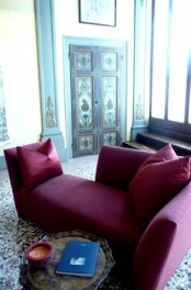 a modern burgundy lounger is a statement idea for a fall-inspired living room