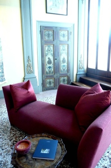A modern burgundy lounger is a statement idea for a fall inspired living room