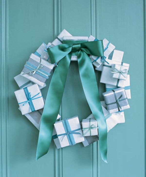Cover small cardboard boxes with wrapping paper and attach to a flat wooden wreath form using a hot glue gun. A ribbon bow would also be an awesome addition to such wreath.