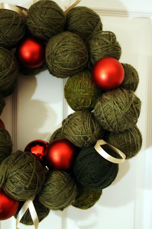 Spin some green yarn and red ball ornaments into a wreath to add a festive, cozy touch to your front door.