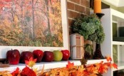 a simple fall mantel with a fall leaf garland, apples and an arrangement of green hydrangeas