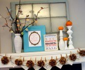 a shabby chic flal mantel with burlap pompoms, branches with bright fall leaves, signs and tiny pumpkins on stands