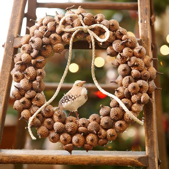 a cute fall wreath covered with acorn tops, with a twine bow, a faux bird will give a woodland feel to the space