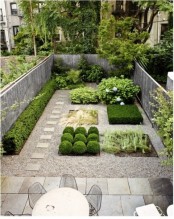 a minimalist townhouse garden with stone tiles, pebbles, stylish plants with no flower beds and a dining set