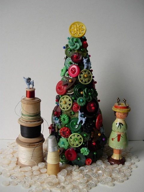 a bright green and red Christmas tree composed of buttons, with spools around for vintage table styling