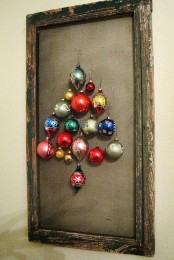 a shabby chic frame with canvas and colorful Christmas ornaments that make up a cool and simple Christmas tree