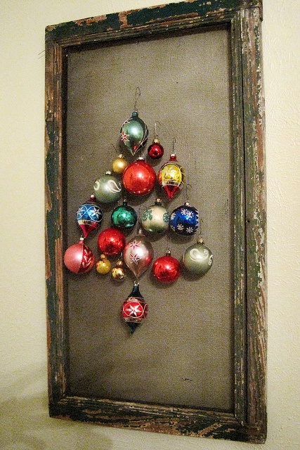 a shabby chic frame with canvas and colorful Christmas ornaments that make up a cool and simple Christmas tree