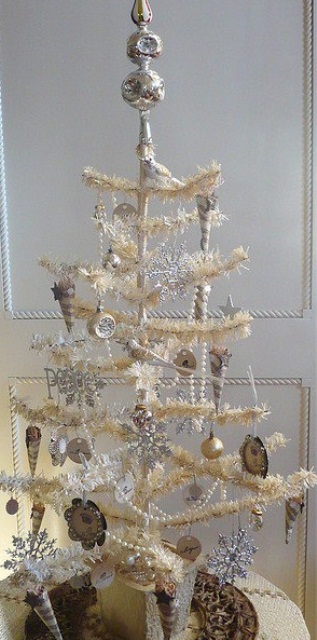 a white Christmas tree with white and silver vintage ornaments and bells plsu silver snowflakes