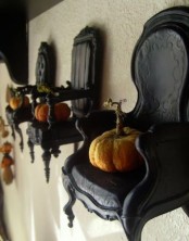 vintage black chairs attached to the walls and with pumpkins on them is a very cute and lovely idea to go for if you love vintage