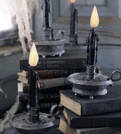black books and candles in black candleholders are amazing for Halloween decor – place them anywhere you want