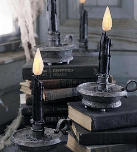Black books and candles in black candleholders are amazing for Halloween decor   place them anywhere you want
