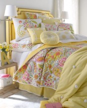 a neutral bedroom with a yellow bed and bright yellow and floral bedding is a lovely idea for spring or summer
