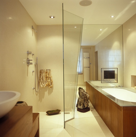a light beige contemporary bathroom accented with white and rich colored wood items and lights