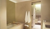 a taupe and white bathroom with touches of dark shades looks very elegant and contemporary