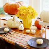 a natural Thanksgiving centerpiece of white and orange pumpkins, a planter with yellow blooms is a gorgeous idea for the fall