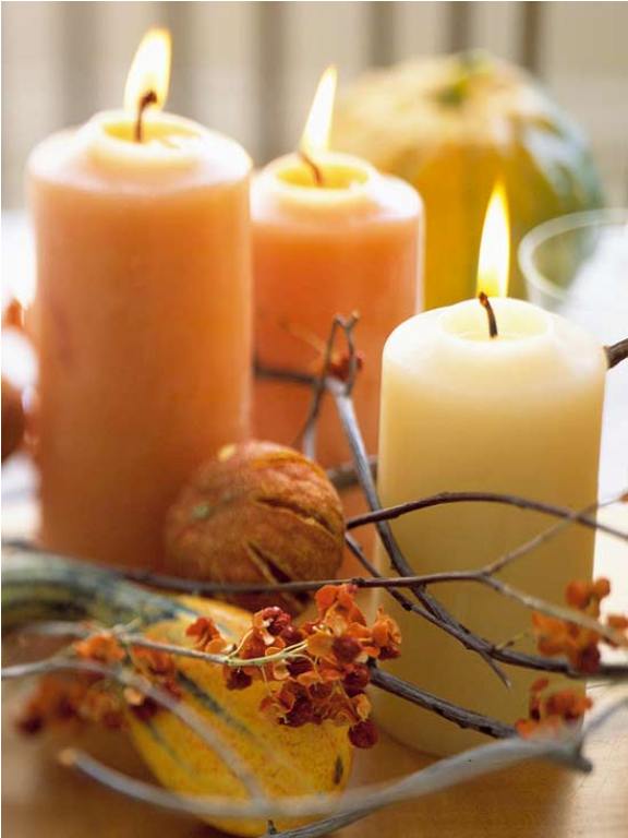 A super natural Thanksgiving centerpiece with natural colored pillar candles, branches, dried blooms is a pretty and cool idea