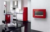 a chic white and red kitchen with red appliances and all white everything, with a black table is a very bright space