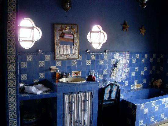 Navy walls, bold blue mosiac tiles with a touch of gold for a Moroccan themed bathroom