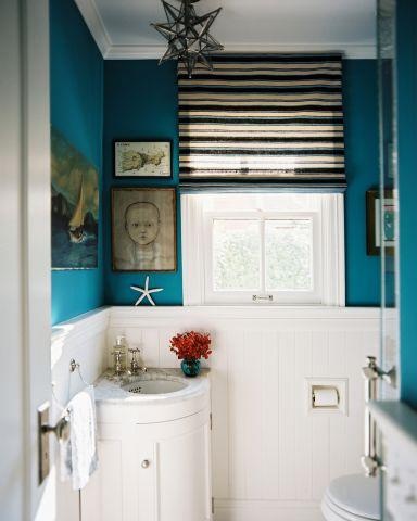 bright blue walls and white paneling are great to make up a cool powder room or bathroom