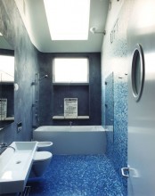 grey concrete paired with mosaic tiles done with an ombre effect from bright blue to white