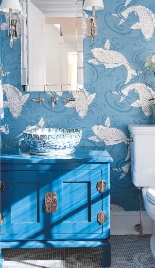 blue fish printed wallpaper and a matching bold blue vanity plus a blue and white enamel vessel sink