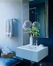 matte navy tiles and a navy tile floor for a chic and bold bathroom plus light blue towels