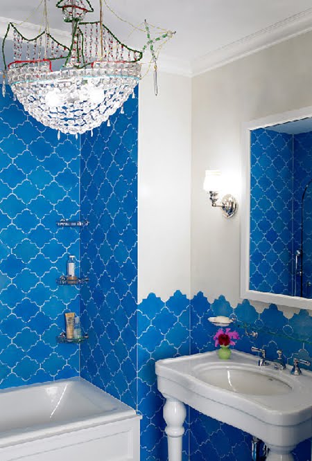 bright blue tiles inspired by Morocco and a crystal chandelier for a bold and modern space