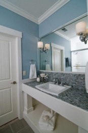 a blue sink space paired with grey tiles on the vanity plus white touches for freshness