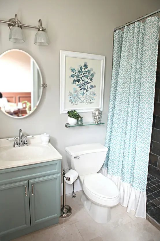 an aqua vanity and a printed aqua and white curtain for a subtle touch of color