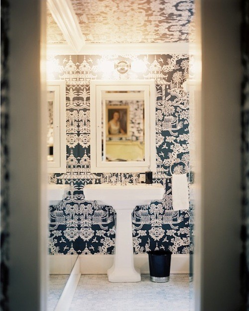 Eye catchy navy and white printed wallpaper on the walls and ceiling plus a white floor