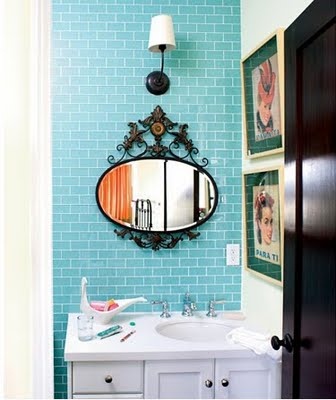 bright turquoise tiles to accent the white vanity and sink plus a mirror in a vintage frame